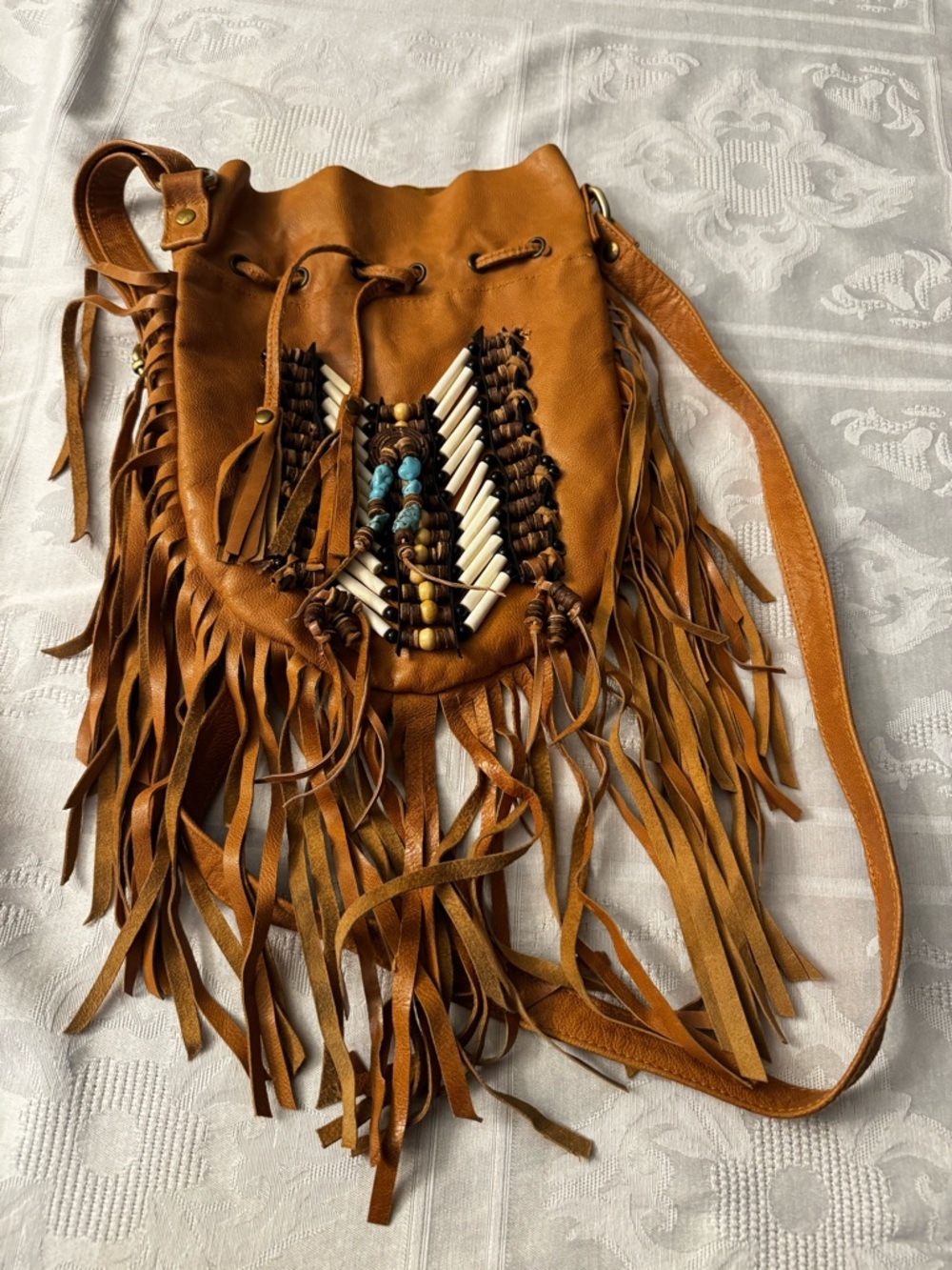 Leather Fringe Drawstring Crossbody Bag in Tan with Beaded Accent